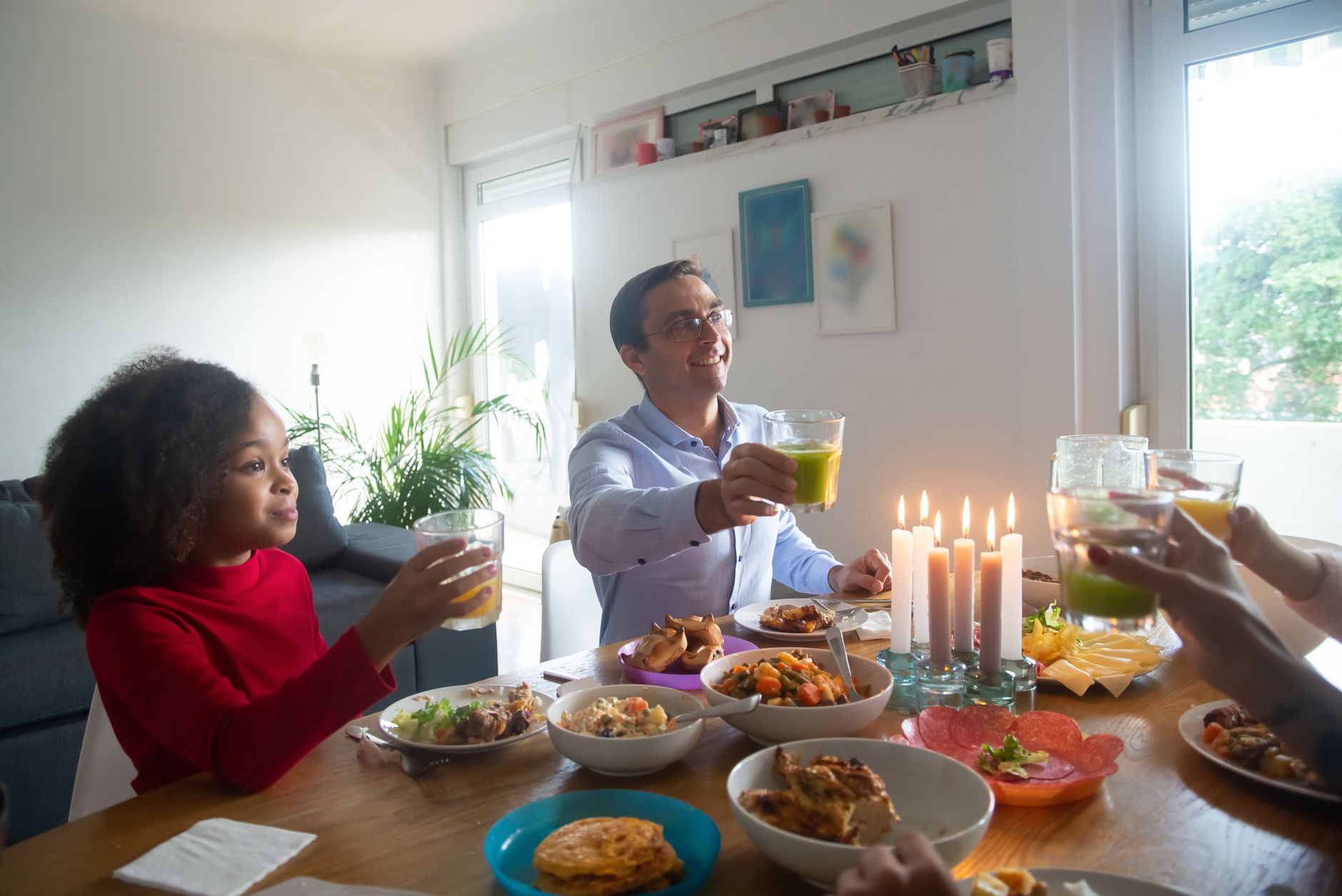 Family gathered around a large timber table