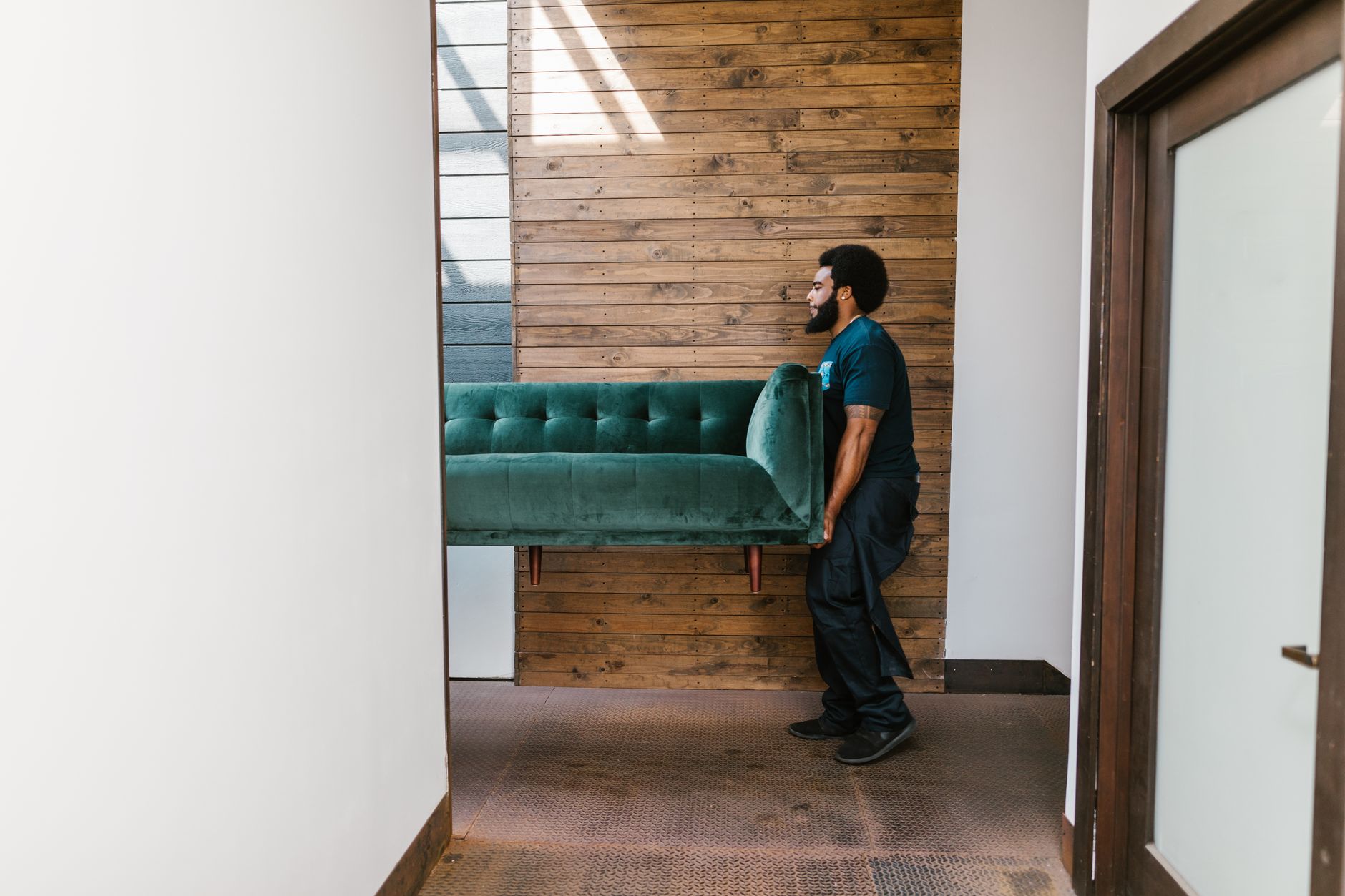 Finished furniture being carried into a home