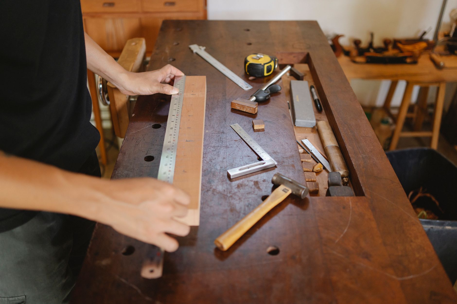 A joiner working timber at the bench